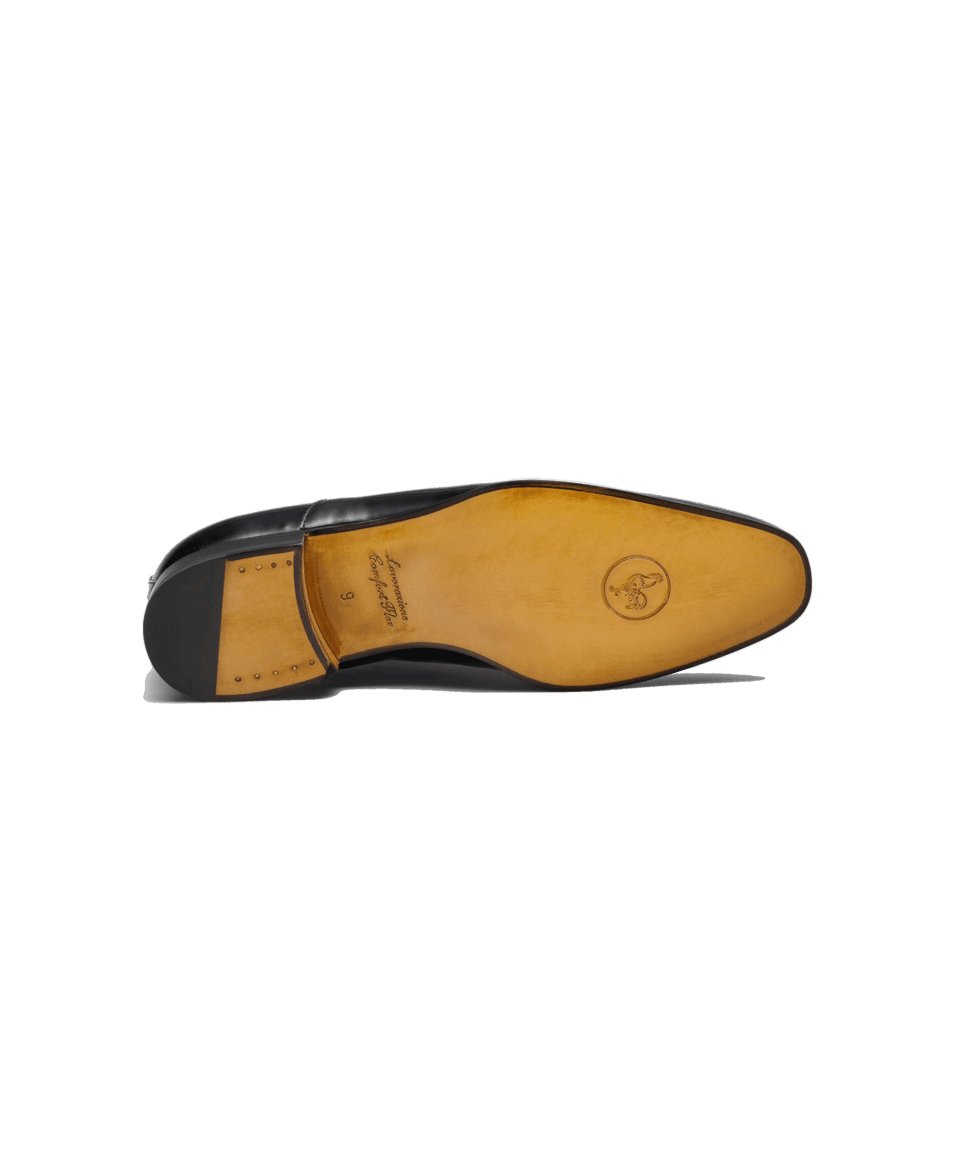 Black patent leather dress shoe with tan leather sole and stamped logo, sole detail view