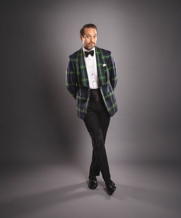 Gordon tartan shawl collar dinner jacket in green and navy with pique shirt and cummerbund, on a model