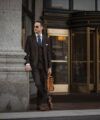 Brown three-piece suit with striped shirt, navy dotted tie and tan brogues, worn by a model in a city street scene