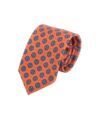 Orange silk necktie with blue and white medallion print, rolled flat lay