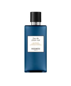 Eau de Citron Noir hair and body shower gel in a blue glass bottle with black cap, product shot