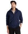 Navy Harrington jacket with stand collar and ribbed cuffs over an oatmeal cable knit, worn by a model