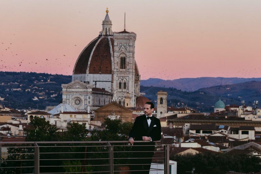 Black dinner jacket with white shirt, black bow tie and pocket square, worn on a Florence rooftop at sunset