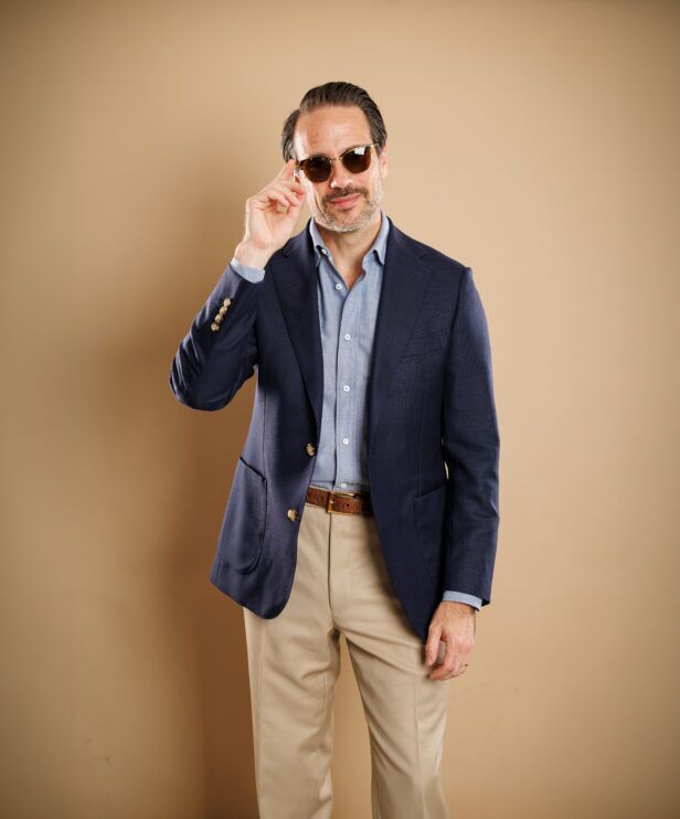 Navy hopsack sport coat with patch pockets, blue chambray shirt and khaki trousers, worn by a model