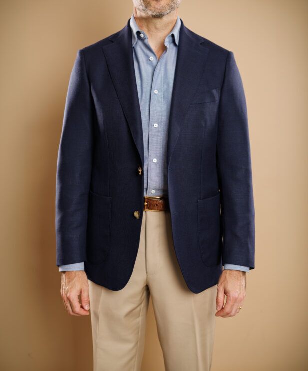 Navy hopsack sport coat with patch pockets, chambray shirt and khaki trousers, worn by a model